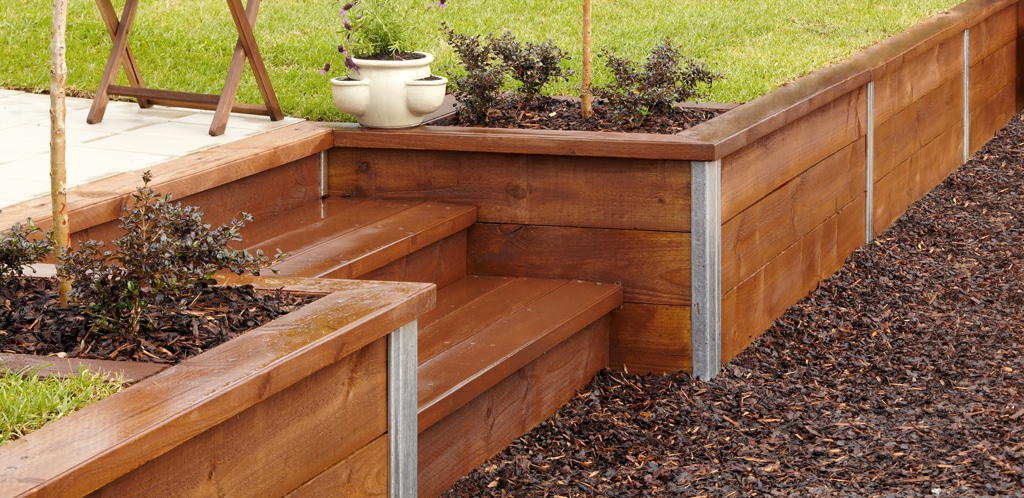 vertical sleeper retaining wall (timber posts flush on ground)