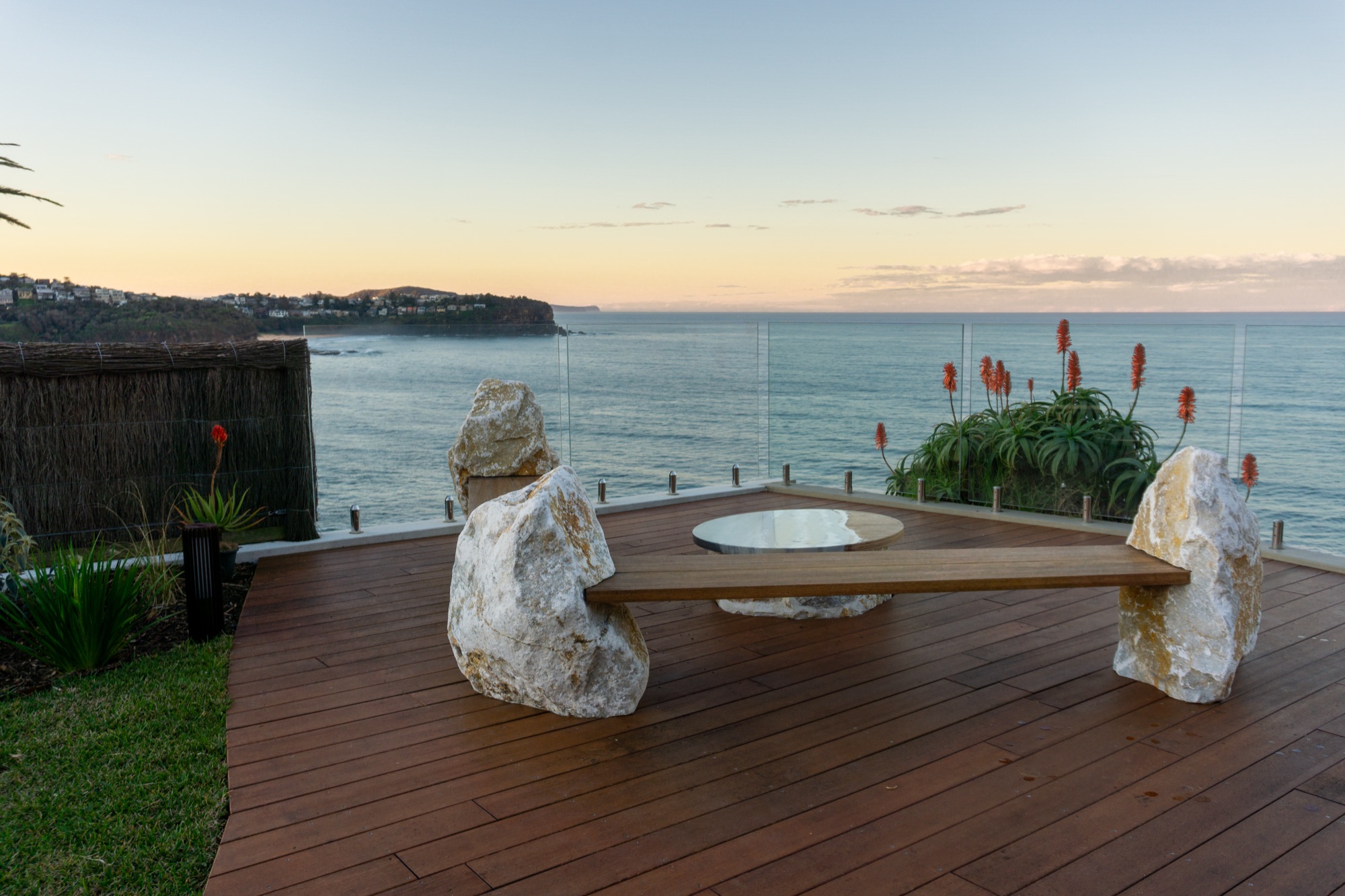 Clifftop deck with custom stone bench overlooking the ocean